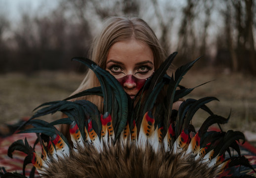 Portrait of a girl dressed as a Native American with roach