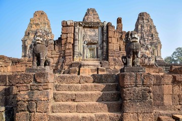 two majestic stone lion statues guarding stairs to ancient angkor wat temple entrance, cambodia