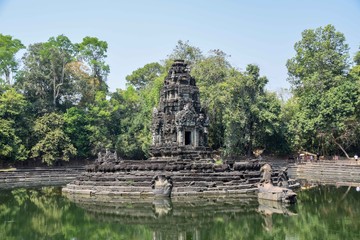 Fototapeta na wymiar mysterious, hidden, abandoned sunken temple ruins in ancient angkor wat, jungle reflecting in lake, cambodia