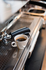 black coffee in white cup on coffee maker
