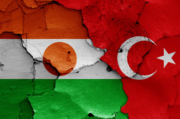 flags of Niger and Turkey painted on cracked wall