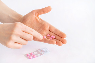 Tablets in hand on a white background close-up.
