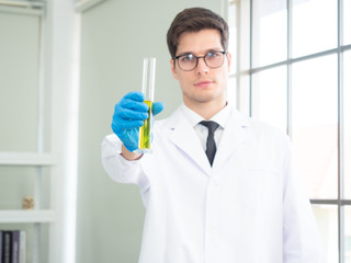 Caucasian handsome male scientists conducting research in a lab environment. Male researcher...