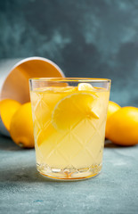 Old fahioned lemon beverage on the rustic background. Selective focus. Shallow depth of field.