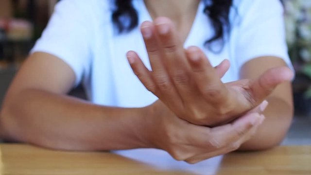Hand exercise with massaging on fingers and palms, Take care of health by exercising to relieve hand pain and cure illness.