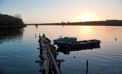 rustic dock in cienfuegos bay at sunset - 327098461
