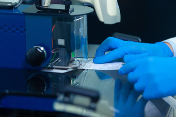 DNA laboratory. The expert puts the human DNA into the database using advanced laboratory technologies