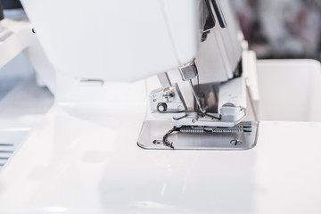 Modern sewing machine (overlock) macro shot. Selective focus. Shallow depth of field.