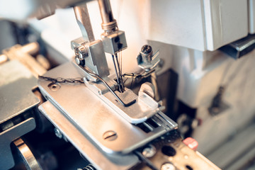 Modern sewing machine (overlock) macro shot. Selective focus. Shallow depth of field.