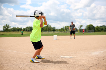 Baseball practice, coach pitching to batter
