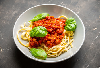 Traditional pasta bolognese with beef and tomatoes the rustic background. Selective focus.