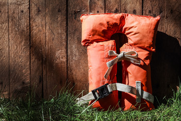 Old vintage life vest on a wooden fence outdoors