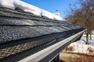 Gutter in winter and snow melted off of roof