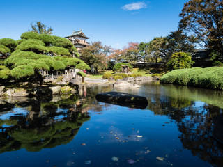 Obraz premium Traditional Japanese public garden with pond near reconstructed Takashima castle in Suwa, Nagano prefecture, Japan
