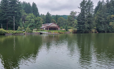 Fototapeta premium Wonderful Lacamas Lake on a breezy cloudy morning with the wilderness reflecting in the calm shimmering water in Camas Washington