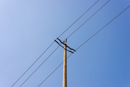 telegraph pole with blue sky background