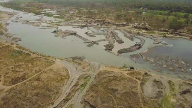 Aerial view excavator and heavy equipment, dredging and deepening the channel mountain river. Heavy dredging machine on river bank. Excavator dredge river. java, indonesia