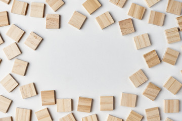 Empty wooden blocks pattern on the white background with copy space, top view