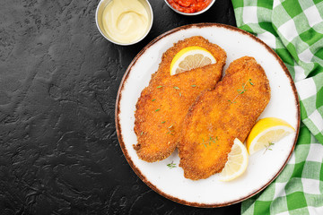 Homemade breaded chicken schnitzel .