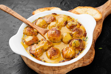 Homemade chicken meatballs in cheddar cheese sauce.