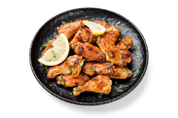 Baked chicken wings served with different sauces and lemon. isolated on white background