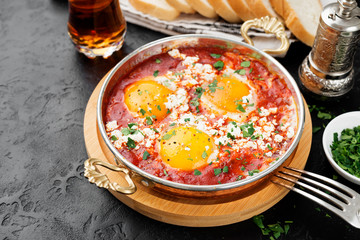 Shakshuka (menemen) fried eggs in tomato sauce for turkish breakfast.