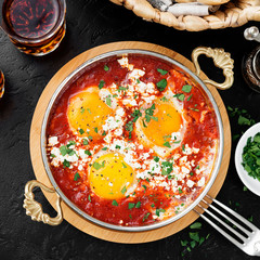Shakshuka (menemen) fried eggs in tomato sauce for turkish breakfast.