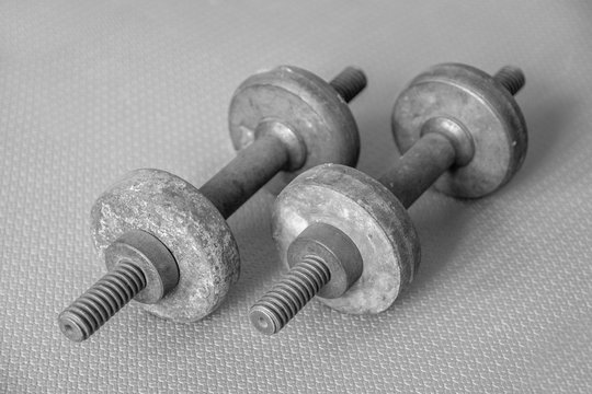 old metal rusty dumbbells in black and white photo