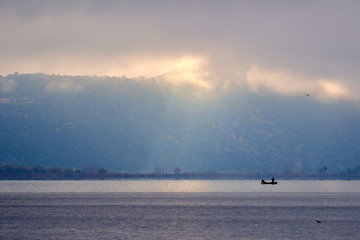 Solitary fisherman in Ioannina lake in the morning