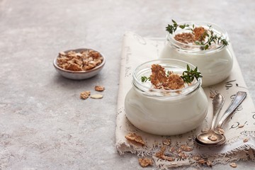 Natural homemade organic yogurt with granola and oatmeal in glass jars.
