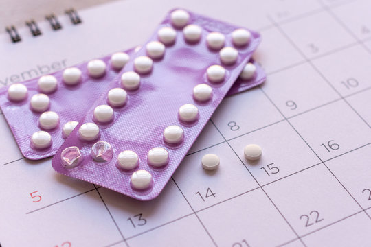 birth-control pill with date of calendar background, health care and medicine concept
