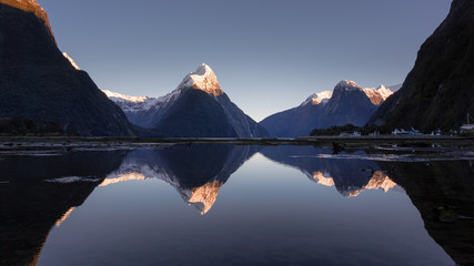 Mirror reflection of Mitrepeak in Milford sound in the morning, south island, New Zealand 