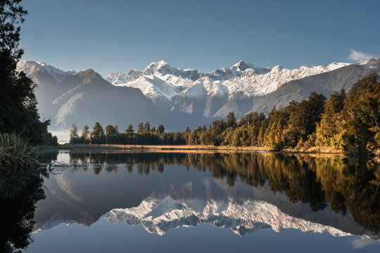 Lake matheson, South Island, New Zealand, with reflection of mount tasman and aoraki mount cook in winter