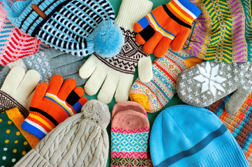 A lot of hats, gloves, mittens. Warm clothes in the form of knitted hats, mittens, gloves, scarves...