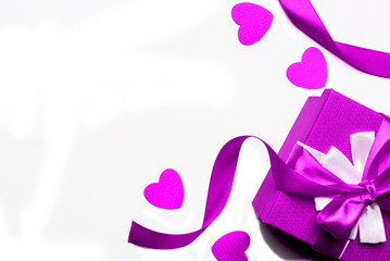 Purple gift box with ribbon and hearts on a white background, isolated image