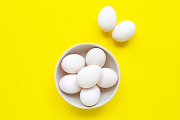 White eggs on yellow background.