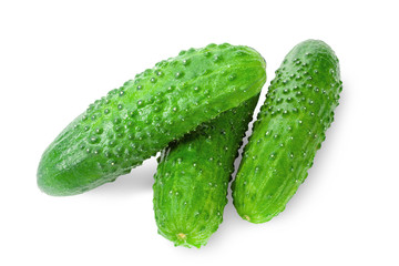 Crispy fresh green cucumbers close-up on a white background.
