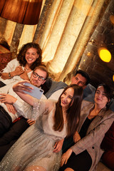 Fototapeta premium Happy group of friends at the bar having drinks.
