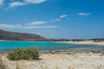 Fototapeta na wymiar Beautiful beach with teal blue waters shot at Elafonhsos Island, Greece.