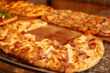 Classic italian fast food – delicious big pizza with ham and cheese
