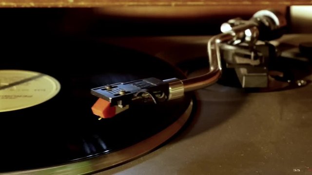 Turntable vinyl record player. The tonearm on a vinyl record.