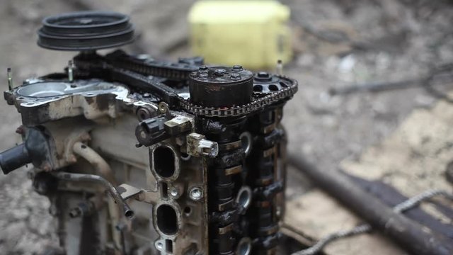 Car engine repare in a garage, close up, shallow DOF
