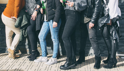 Detail of a group of friends in the street. Lifestyle