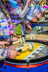 Group of people in carnival playing the drum.