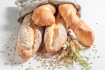 Tasty french baguettes for breakfast in linen bag