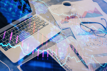 Financial graph colorful drawing and table with computer on background. Double exposure. Concept of international markets.