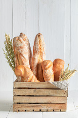 Homemade french baguettes for breakfast in wooden box