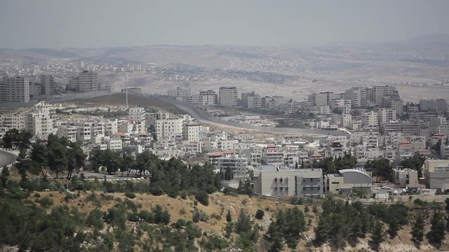 Cars drive in jerusalem next to separation wall, Mount Scopus, Israel Palestine