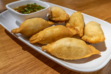 Chinese dumplings on plate with dipping sauce