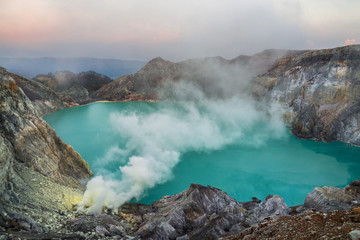 Blue sulfur acidic lake of Mount Ijen volcano with poison smoke on East-Java, Indonesia